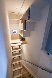 Make Use Of The Dead Space Above The Existing Stairs The Stairs Raise Up When The Library Isn Over Stairs Storage Staircase Storage Stairs For Tight Spaces