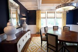 Navy colorizes all sides of the wall which makes this dining room look so elegant while the white ceiling brightens it up. Navy Blue Dining Room With Midcentury Buffet And Yellow Rug Hgtv