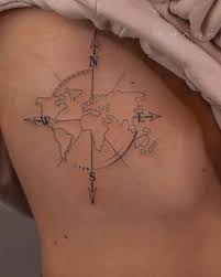 Because both are used for navigation, a compass and a map are the ideal tattoo combination. Compass Rose And World Map Tattoo On The Ribcage