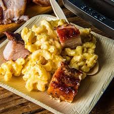 The dish is placed on a baking sheet with foil to prevent the cheese from dripping and catch the bubbles to enhance cleanliness. Baked Pork Belly Mac And Cheese Recipe Traeger Grills