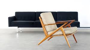 Its backrest and seat areas are soft and upholstered with neutral grey material. Danish Modern Z Lounge Chair By Poul Jensen Selig