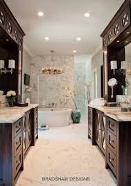Bathroom Vanity Areas Facing Each Other Walk In Shower Behind Free Standing Tub Walls Sheathed In Marb Elegant Bathroom Dark Brown Cabinets Bathrooms Remodel