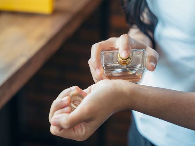 Applying fragrance to highly reactive pulse points, AI generated