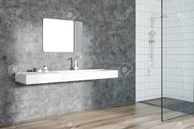 Download this premium photo about modern bathroom with wooden floor, and discover more than 7 million professional stock photos on freepik. Modern Bathroom Interior With Concrete Walls A White Sink With Stock Photo Picture And Royalty Free Image Image 98418577