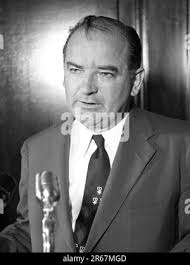 Senator Joseph McCarthy standing at microphone, Joseph Raymond "Joe"  McCarthy (1908