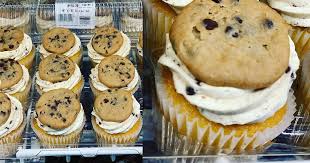 Costco isn't just the place for giant packs of paper towels and toilet paper: Costco Is Selling Cupcakes Topped With A Whole Chocolate Chip Cookie