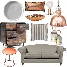 Grey living room with hints of orange from the pillows, glass decors, and hardwood flooring. Pin On Living Room Project