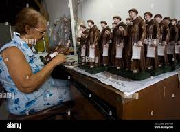 Maria Jose Salles, 70, paints figures of Antonio de Sant'Anna Galvao, known  as Friar Galvao, at a factory in Guaratingueta, Brazil, Wednesday, Feb. 28,  2007. Pope Benedict XVI will canonize Friar Galvao,
