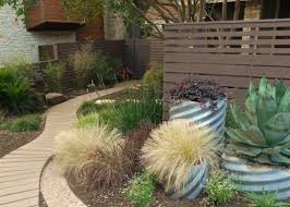 Behr Premium Water Based Stains Woodchip On The Fence And Boot Hill Grey On The Curved Path Stained Horoz Mexican Feather Grass Feather Grass Landscape Design