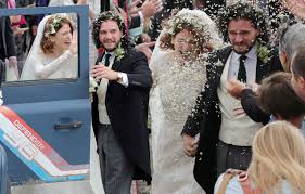 .sleeve stunning white lace wedding dress with floral appliques, a white flower crown and cathedral veil and carried a bouquet of white roses. Kit Harington And Rose Leslie Marry In Scotland