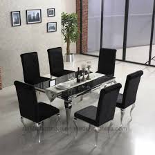The table has tall standing legs and boasts of a coated finish, making it an ideal choice for modern sophisticated decors. China Modern Cheap Customized 6 Seater Glass Dining Table China Modern Dining Table Chinese Furniture