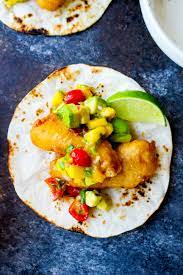 Top with purple cabbage, white corn kernels, spicy california avocado cream and mango salsa. Beer Battered Fish Tacos With Mango Avocado Salsa Spicy Ranch Drizzle
