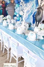 The Winter Table Settings With A Fantastic Blue Sparkly Table Cloth At This Frozen Birthday P Elsa Birthday Party Frozen Bday Party Frozen Birthday Decorations