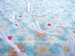 Patterned fabrics can be easier to work with since you can use the actual pattern as a guide to making your fringe cuts. How To Make A Tie Quilt Blanket Adventures Of A Diy Mom