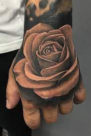 A large back tattoo that stretches across the shoulders. Hand Rose Tattoo Inkstylemag Rose Hand Tattoo Hand Tattoos Trendy Tattoos