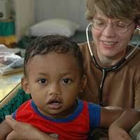 Lt. Cmdr. Jonathan Auten, the emergency medicine residency assistant  director and emergency medicine physician at Naval Medical Center  Portsmouth, makes a balloon for a pediatric patient at Hospital Nacional  Infantil Elisa Martinez. -
