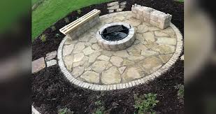 A deep hearth with an array of pillows creates extra seating for guests around this outdoor fireplace of montana ledge stone. Fire Pit Patio Stone Benches Project By Sharlene At Menards