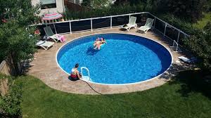 A Small Yard Doesn T Mean You Can T Have Your Own Backyard Escape The Radiant Metric Round Ins Inground Pool Landscaping Pool Landscaping Small Backyard Pools