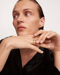 2 wavy eternity rings: one set with light blue zirconia & the other...