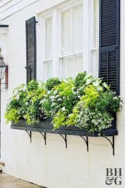 Metal brackets bolted to the wall can extend your windowsills, as well as help to secure the containers. How To Plant A Stunning Window Box Like A Pro Window Box Plants Window Planter Boxes Window Box