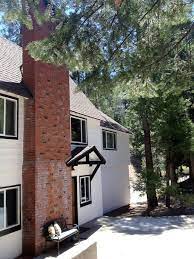 This house achieves a perfect balance from its dark roofing, black exterior, and white trims. Classic White House With Black Trim And Brick Updating House Lake House American Style House