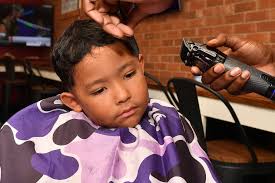 Dante Machuca of Raleigh gets ready for the new school year with a fresh  haircut at the Kappa Center. On August 16, 2025, the Raleigh chapters of  Kappa Alpha Psi and Sigma