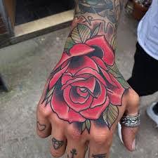 The designs can picture a stylized version of a rose (usually black) or incorporate a rose in tribal patterns. 50 Amazing Rose Hand Tattoos