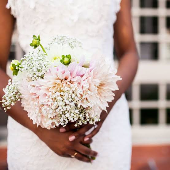 a mix of pastel pink dahlias and white baby's breath
