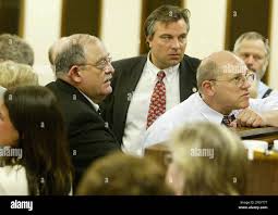 Reps. John Coghill, R-North Pole, right, Nick Stepovich, R-Fairbanks,  center, Norman Rokeberg, R- Anchorage, left, and other legislators discuss  the tobacco tax with House Speaker Pete Kott, not seen, after learning the
