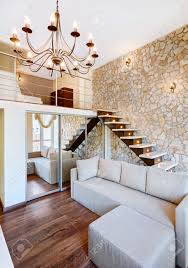 Maybe you would like to learn more about one of these? Modern Style Two High Living Room Interior With Staircase And Stone Wall Stock Photo Picture And Royalty Free Image Image 17799270