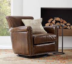 Our compact version of the classic club chair offers all the comfort of the original but in a smaller silhouette that's just right for a library, den or small living room. Irving Roll Arm Leather Swivel Armchair With Nailheads Pottery Barn