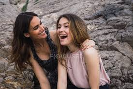 Two friends laughing loud at home. Two Young Female Friends Laughing In Front Of Big Rock Summer Teenager Stock Photo 222627804