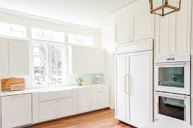 Wood has a way of making this color look organic. Off White Wood Panel French Door Refrigerator With Brass Door Handles Transitional Kitchen