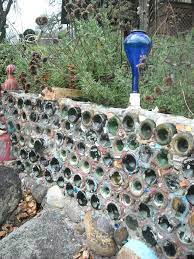 Garden glass bottle retaining wall. Re Used Bottles As Garden Wall Garden Wall Decor Bottle Garden Herb Garden Wall