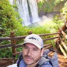 What town to stay in near San Jose for hiking to waterfalls and surfing in  Quepos, Costa Rica?