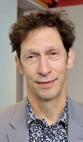 Here's a picture of Tim Blake Nelson aka "Looking Glass" looking clean and  slick! So he doesn't get type cast in every upcoming role as the scruffy  nutty guy in the basement