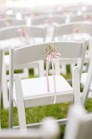 Delicate Baby S Breath Ceremony Decor Tied To White Folding Chairs With A Pink Ribbon Wedding Chair Decorations White Folding Chairs Pool Lounge Chairs