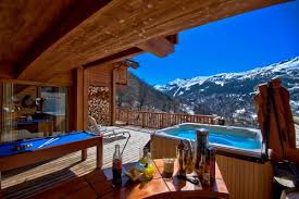 Located above the lobby, four premier king condo with hot tub provides the ultimate relaxation for honeymoons and special celebrations with king size mountain luxury bed located in a loft, cozy living room with fireplace and full kitchen, and a private balcony with outdoor hot tub overlooking the amazing mountain vistas of banff. Meribel Chalets With Hot Tub
