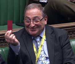 SNP MP brandishes red card at Theresa May after Tory MP Douglas Ross missed  day in parliament to run line at Champions League match