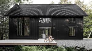 Nestled into the hillside sits this new amish farmhouse with a textured black abm panel metal roof. Appareil Architecture S Black Metal Cabin Hides In A Quebec Forest