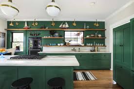 The cabinets in this kitchen were painted green to highlight the stained glass door, copper hood and terra cotta floor. Forest Green Kitchen Kathy Kuo Blog Kathy Kuo Home Kathy Kuo Blog Kathy Kuo Home