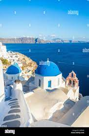 White greek church with blue dome & pink bell tower, Oia, Santorini, Thira,  Cyclades Islands, Greek Islands, Greece, EU, Europe Stock Photo - Alamy