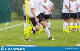 Boy Soccer Player In Training. Boy Running Between Cones During ...