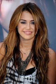 Chunky highlights long medium brown pigtail braids platinum blonde highlights straight yellow highlights A Ranking Of Our Favorite Miley Cyrus Hairstyles Plus Her Latest Do Celebrity Hair Livingly