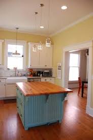 The gray walls, wood island, and the glass mosaic tiles used as a blacksplash make for. Modern Vintage Kitchen Design Ideas Pictures Remodel And Decor Yellow Kitchen Walls Eclectic Kitchen Kitchen Color Yellow