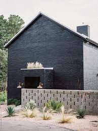 Texas house with dramatic black brick cladding. Exterior Of A Modern Black Brick House By Kristen Curette Daemaine Hines
