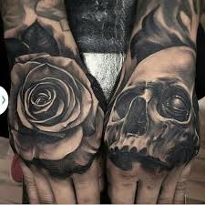 Black And Grey Rose And Skull Tattoo Hand Tattoos Hand Tattoos For Guys Skull Hand Tattoo