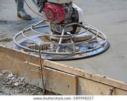 The power pole finisher lets workers finish concrete slabs from outside the formed area. Shutterstock Puzzlepix
