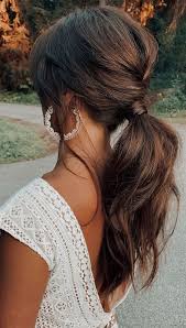 A ponytail is a hairstyle in which some, most or all of the hair on the head is pulled away from the face, gathered and secured at the back of the head with a hair tie, clip. High And Low Ponytails For Any Occasion Braided Low Ponytail