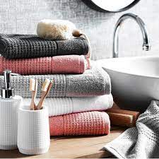 The color coral is one of those beautiful hues that surprisingly works with a broad range of decorating styles. Bed Bath N Table Towels Coral Bathroom Decor Bathroom Towels Bathroom Styling